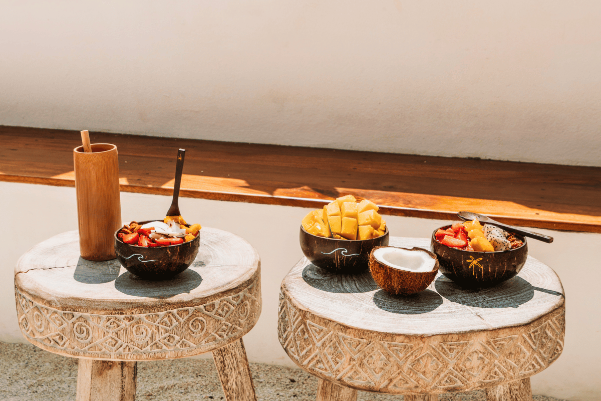 Coconut shell bowls showcased outdoors with smoothie and fruit outdoors